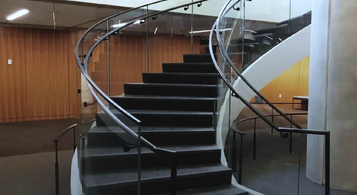 Bank of Canada, Ottawa: Curved stair with dark treads, handrail and full-height glass guardrail panels