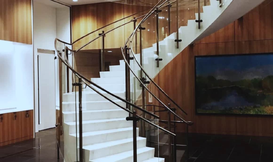 Bank of Canada, Ottawa: Curved staircase with glass guardrails in a wood-panelled lobby