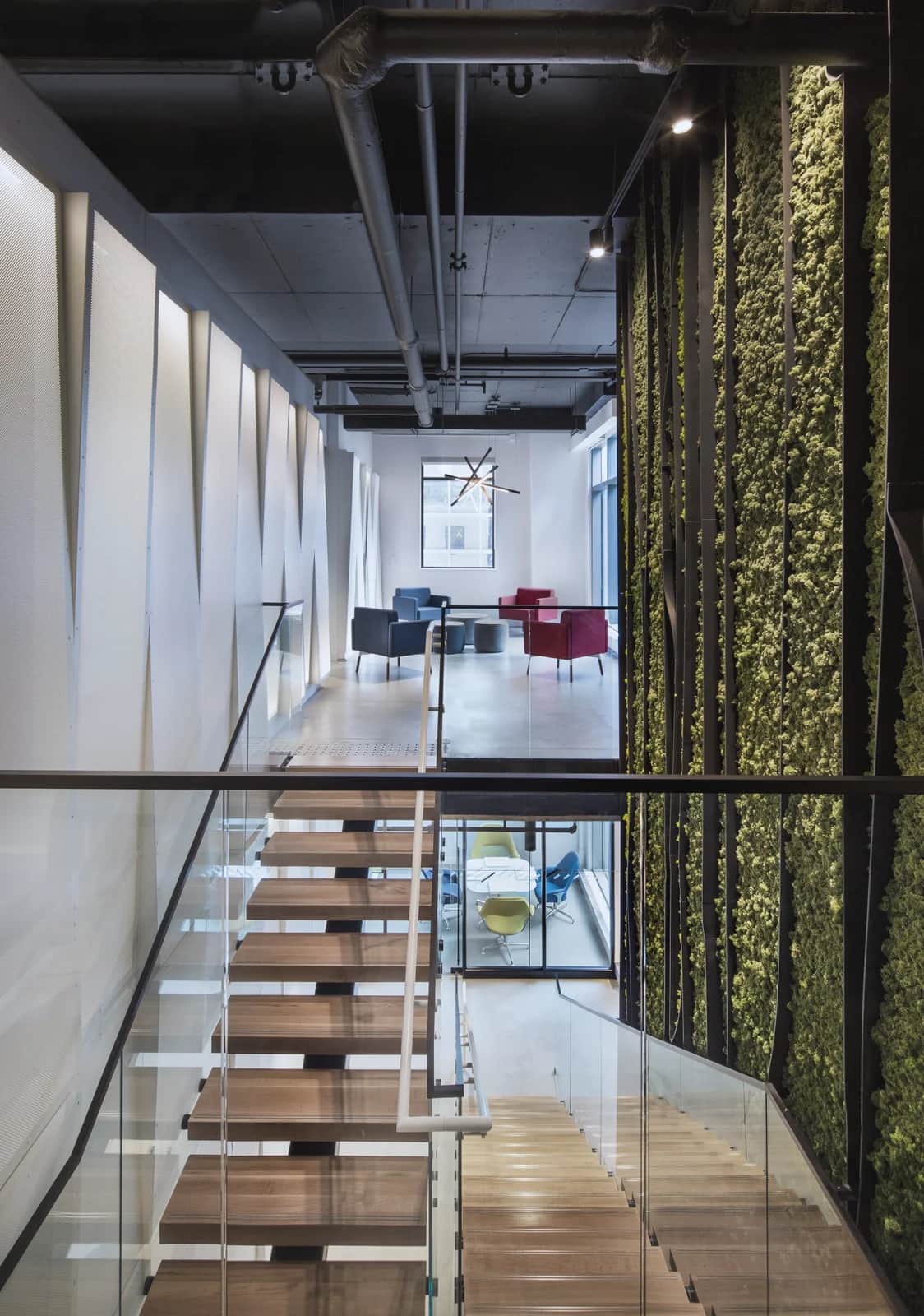 Living-wall stair, Toronto: Open-riser stair with timber treads and a glass guardrail, running beside a living moss wall