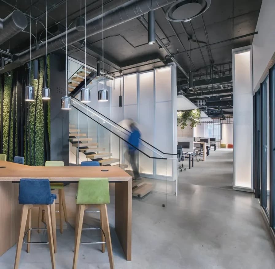 Living-wall stair, Toronto: Office stair with glass guardrails beside a green moss wall